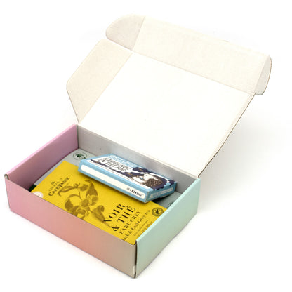 An open pastel-colored gift box containing a 5 wrapped chocolate bars, photographed on a white background.