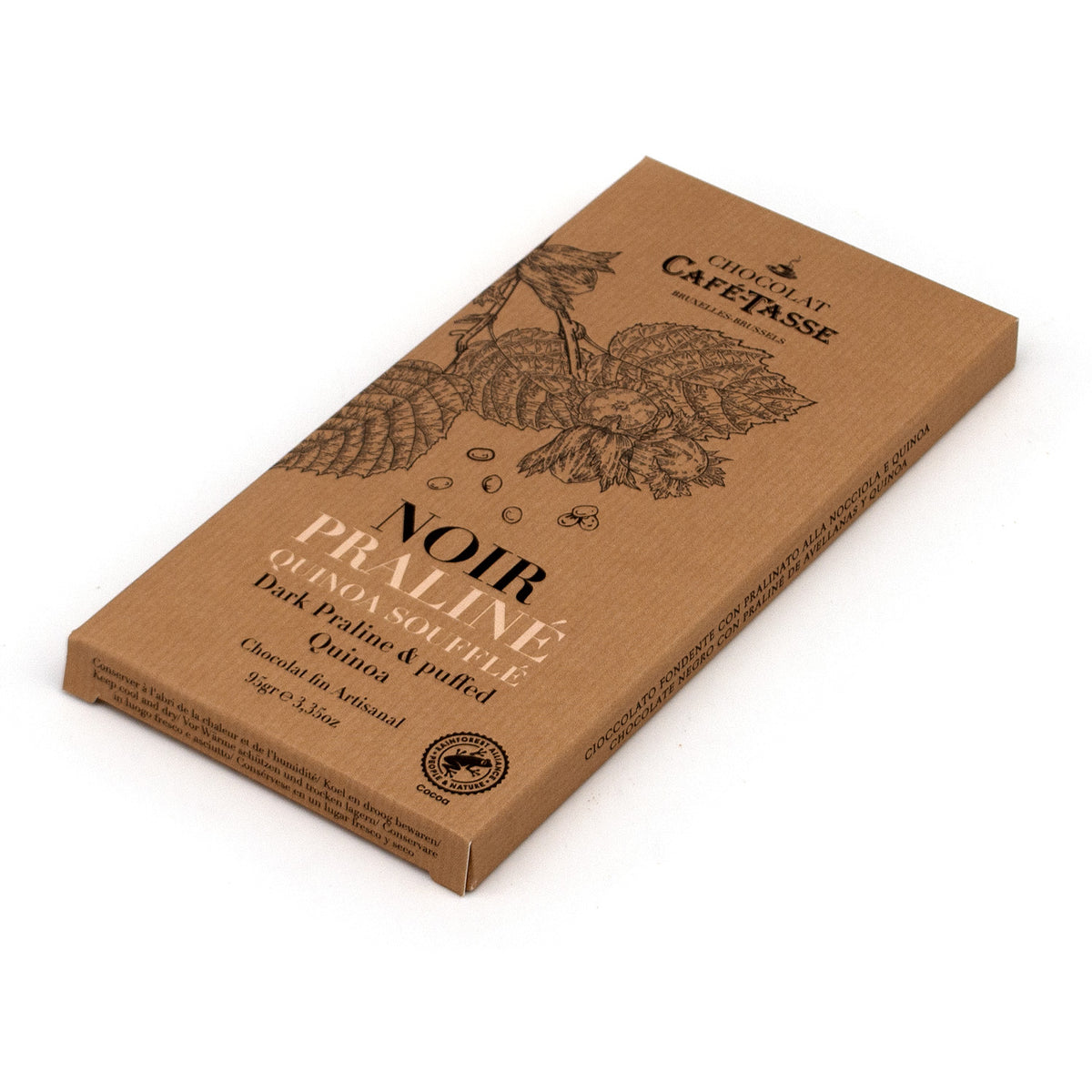 A rectangular chocolate bar package from Chocolat Café-Tasse, featuring a kraft brown cardboard design with black botanical illustrations and text reading 'NOIR PRALINÉ.