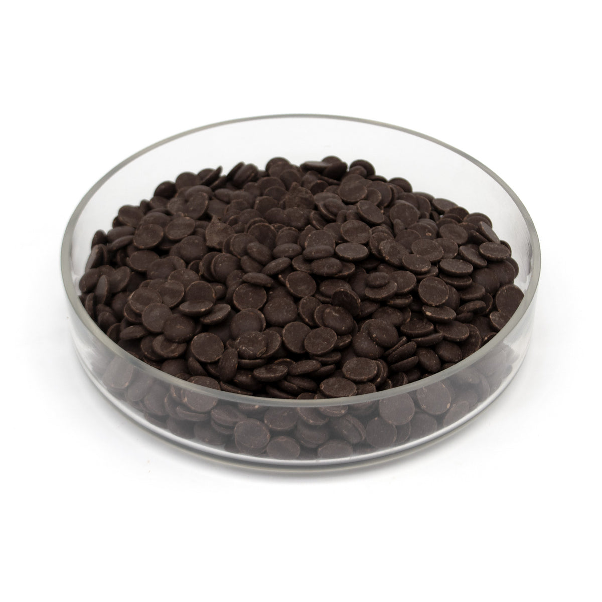 Dark brown chocolate chips piled in a clear glass bowl on a white background.