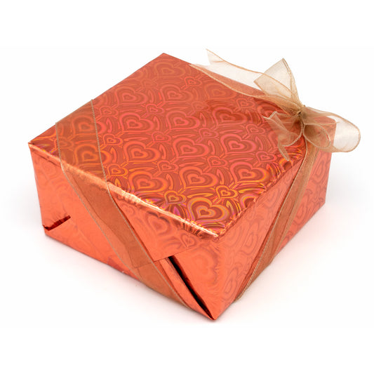 Orange gift box with heart pattern and a beige ribbon on a white background