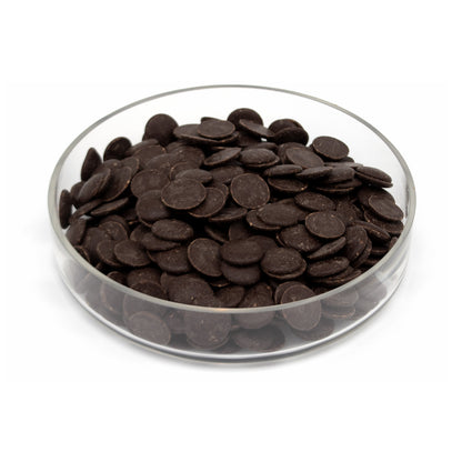 Dark chocolate wafers in a clear glass bowl, photographed on a clean white background.
