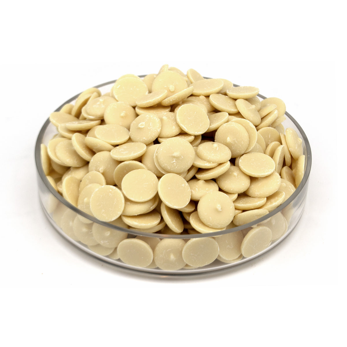 A pile of small round cream-colored chocolate wafers displayed in a clear glass bowl on a white background.