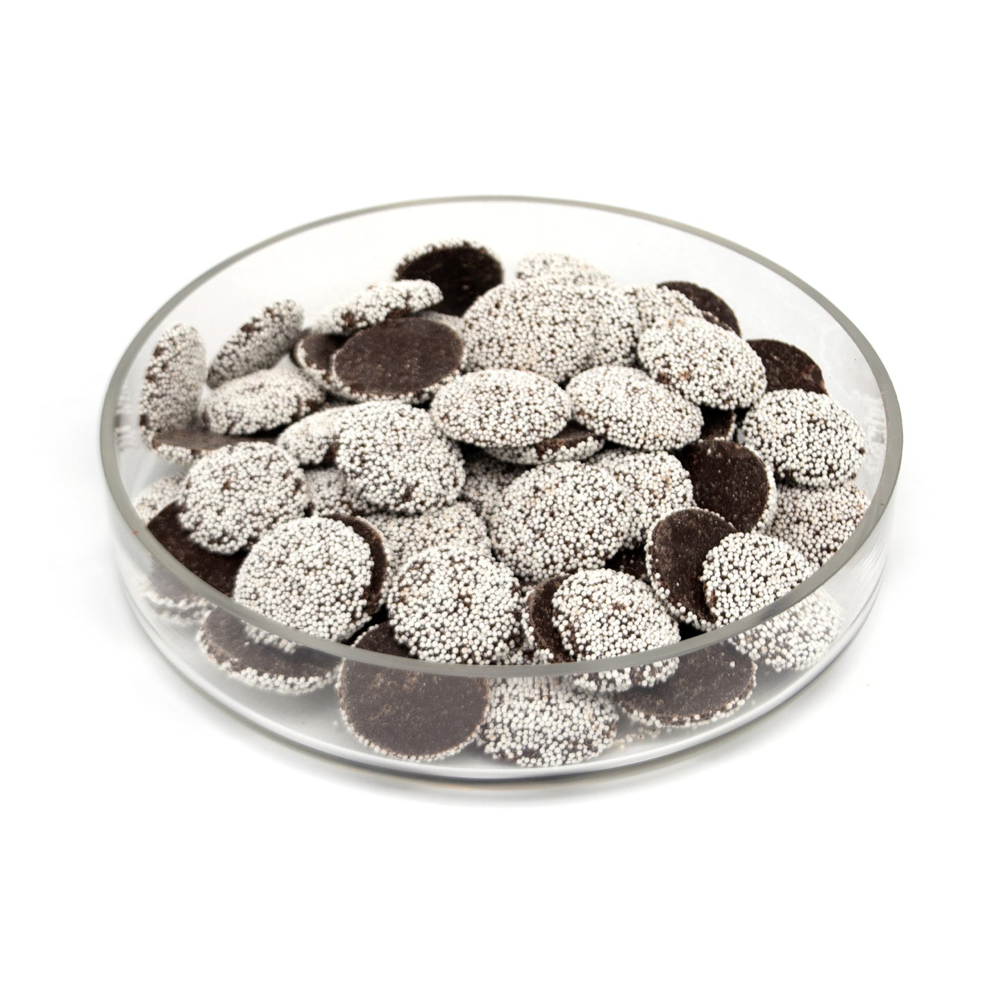 A clear round glass dish filled with dark brown chocolate discs topped with white sprinkles, photographed on a plain white background.