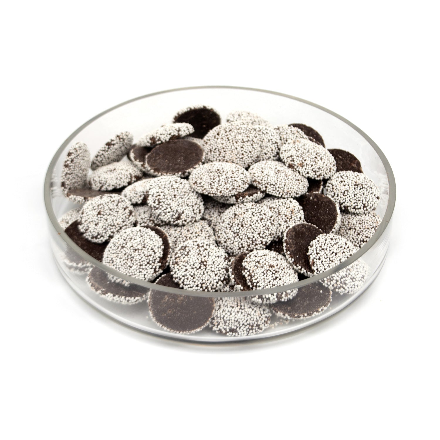A clear round glass dish filled with dark brown chocolate discs topped with white sprinkles, photographed on a plain white background.