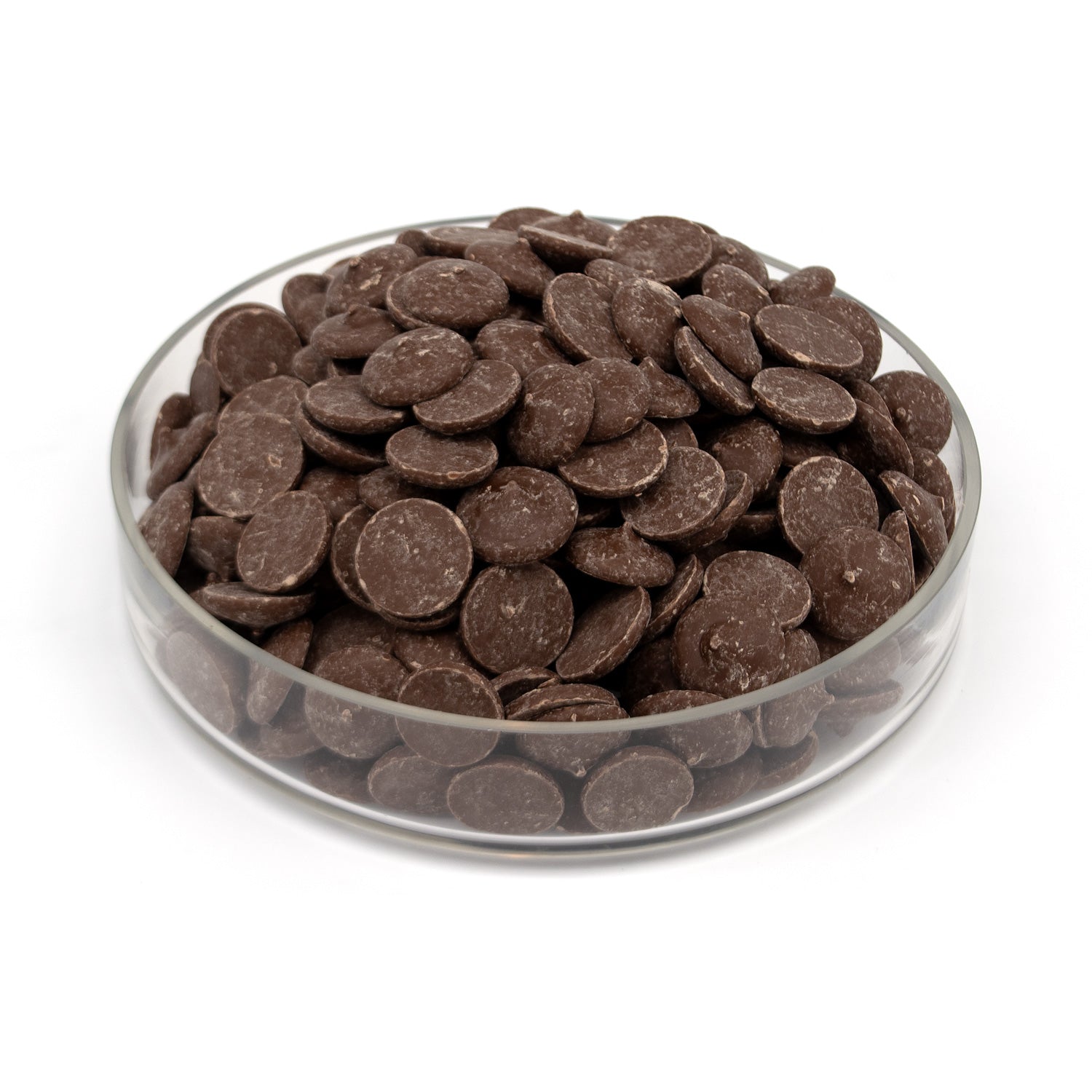 A pile of dark chocolate wafers in a glass bowl photographed on a white background