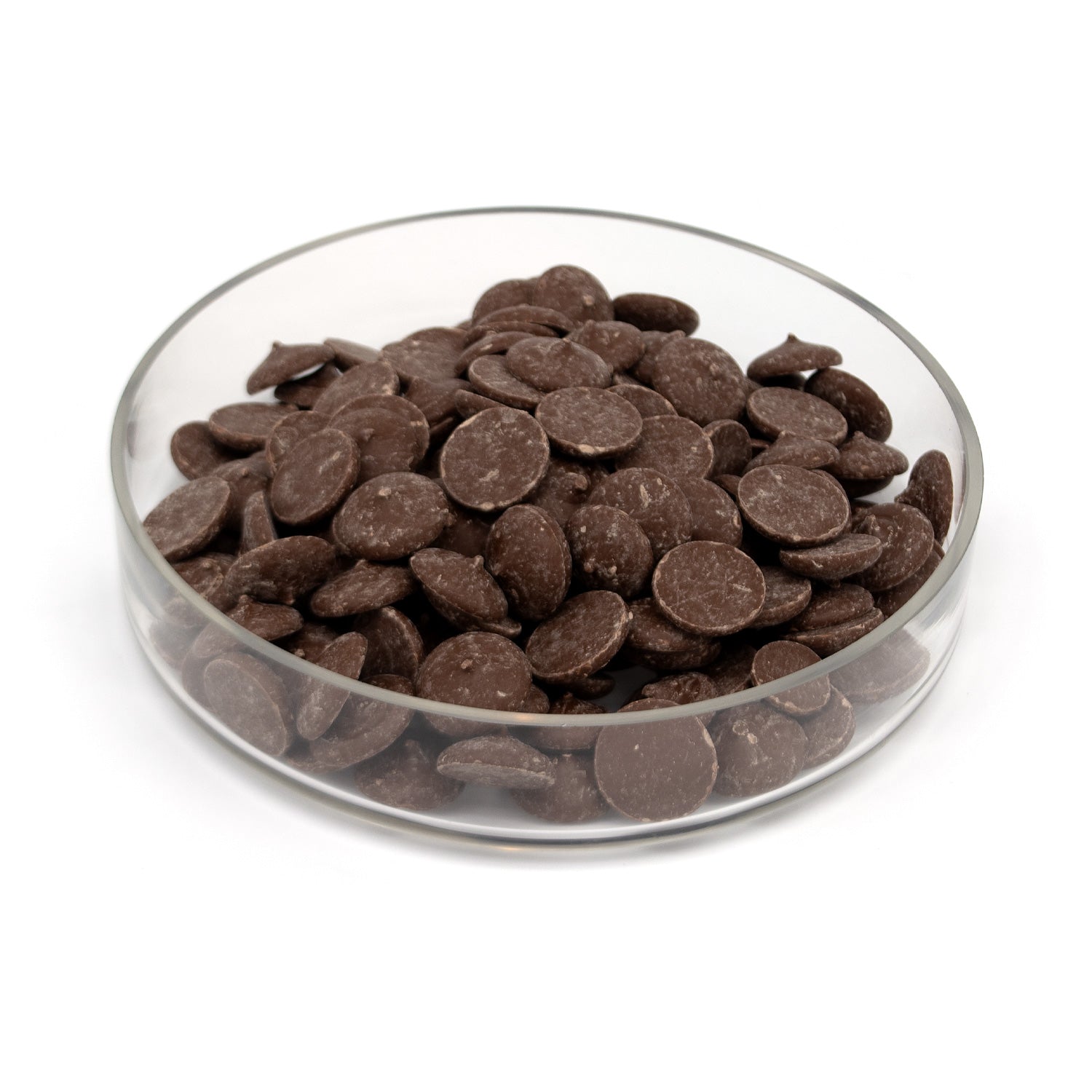 A pile of dark chocolate wafers in a glass bowl photographed on a white background