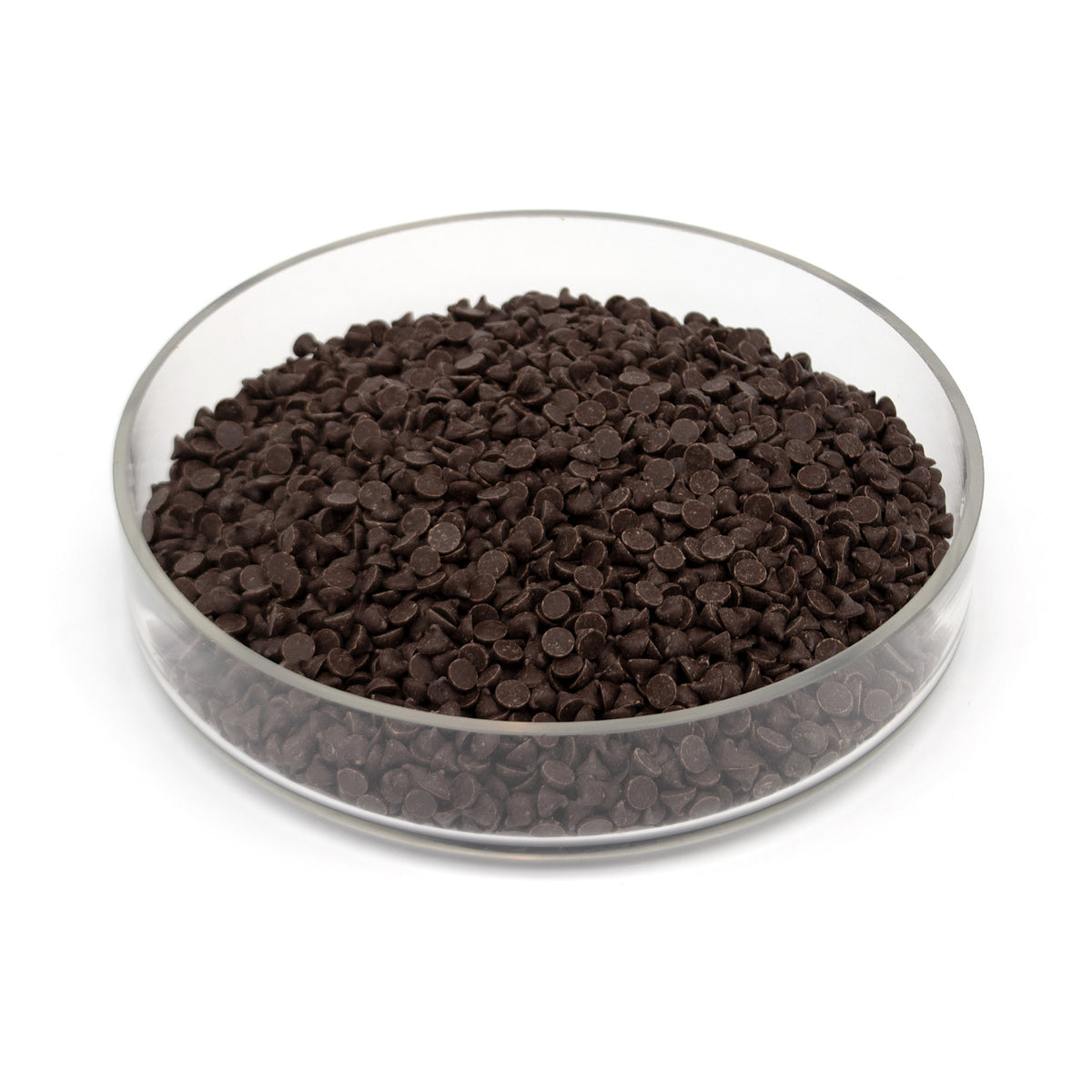 Glass bowl half filled with small dark brown chocolate chips on a white background