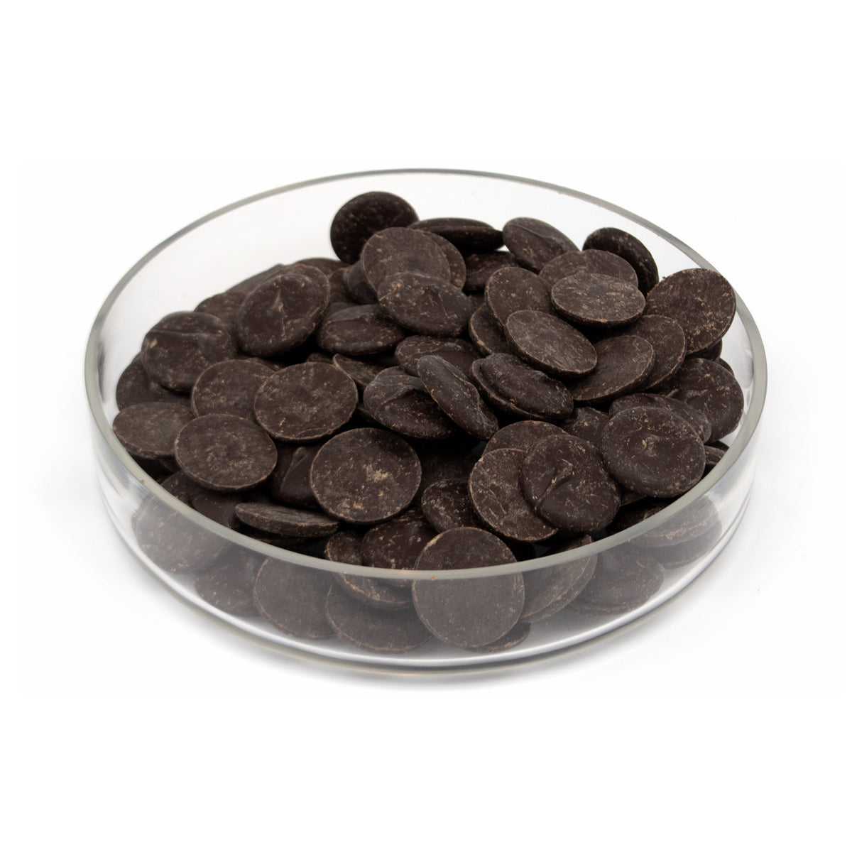 Glass bowl filled with dark chocolate wafers on a white background