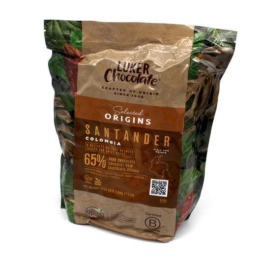 A 2.5 kg bag of Luker Chocolate Selected Origins Santander Colombia 65% dark chocolate, featuring a design with brown & beige tones.