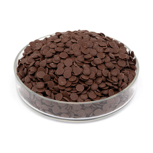 Glass bowl filled with brown chocolate chips on a white background