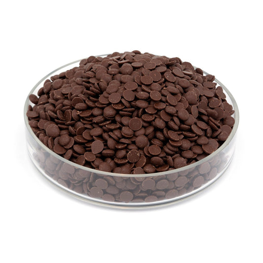Glass bowl filled with chocolate drops on a white background
